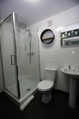 a bathroom with a shower and a toilet and a sink at Kings Arms Hotel in Melrose