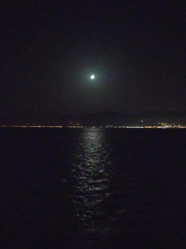 a full moon over the water at night at Affittacamere da chris in Reggio Calabria