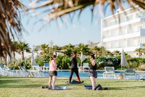 a group of people doing yoga by a pool at Lixus Beach Resort - All In in Larache