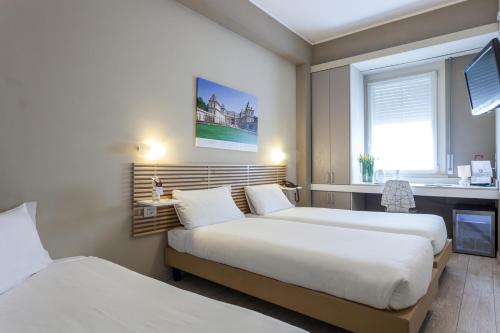 a hotel room with two beds and a window at Best Quality Hotel Gran Mogol in Turin