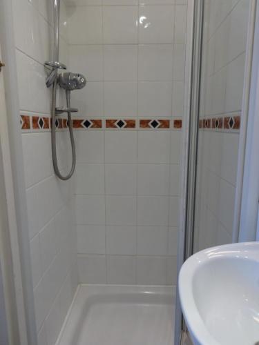 a bathroom with a shower and a sink at Dumfries Villa in Dumfries