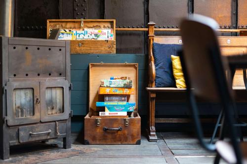 a room with a stove and a bed and a chair at B&B Vita Nova in Amersfoort