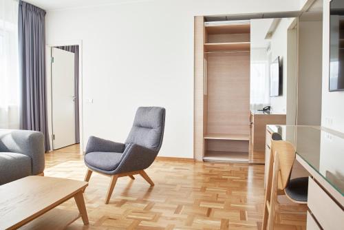 a living room with two chairs and a table at Tallink Spa & Conference Hotel in Tallinn