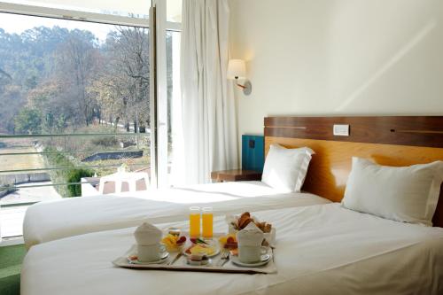 Llit o llits en una habitació de Hotel Braga Falperra