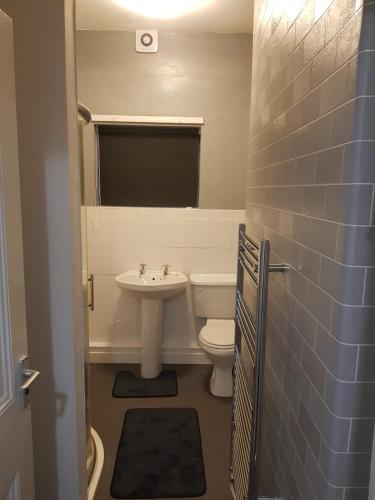 a bathroom with a white toilet and a sink at Highfields House - Free Wifi - Free Local Parking in Sheffield