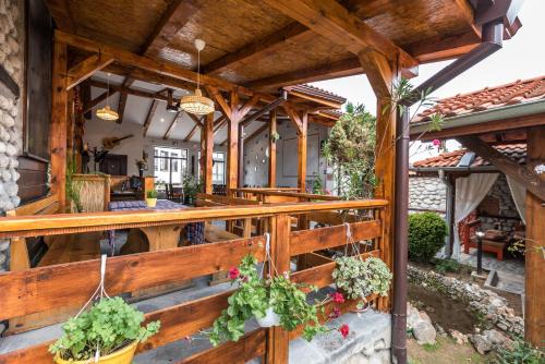 an outdoor patio with a wooden fence and potted plants at Hotel Ida in Bansko