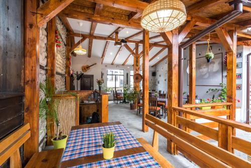 a dining room with a table and benches at Hotel Ida in Bansko