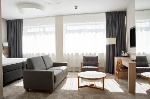 a living room with a couch and a bed at Tallink Spa & Conference Hotel in Tallinn