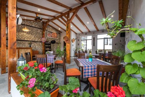 a restaurant with a table and chairs and flowers at Hotel Ida in Bansko