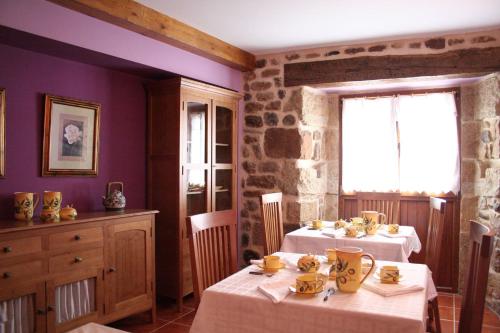 a dining room with two tables and a window at Posada El Arrabal in Arenas de Iguña