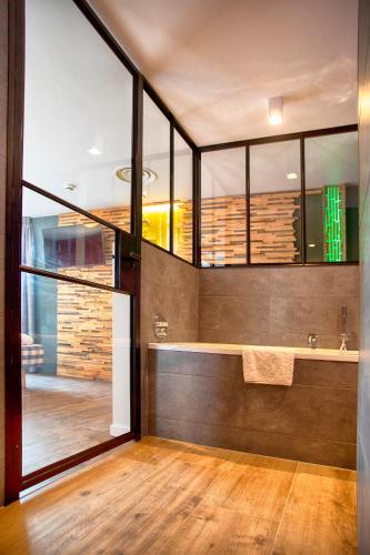 a bathroom with a sink and a large window at Boutique Hotel, Restaurant & Wellness Westerburcht in Westerbork