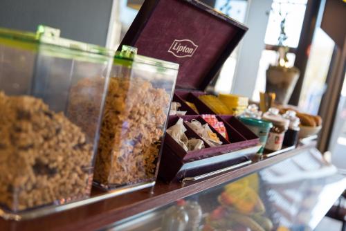 a counter with a bunch of different types of food at Le Merceny Motel in Bastogne