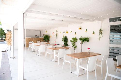 a row of tables and chairs in a room at Hotel San Giovanni in Polignano a Mare