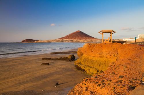 a sandy beach with a sign on top of it at Casa Grande Surf Hostel in El Médano