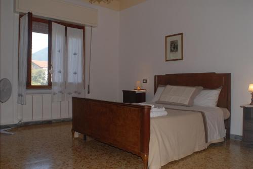 a bedroom with a large bed and a window at Casa Vacanza La Palma in Massa