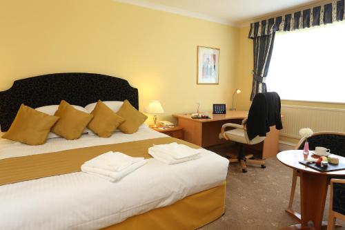 a bedroom with a bed and a desk and a chair at Tiverton Hotel Lounge & Venue in Tiverton