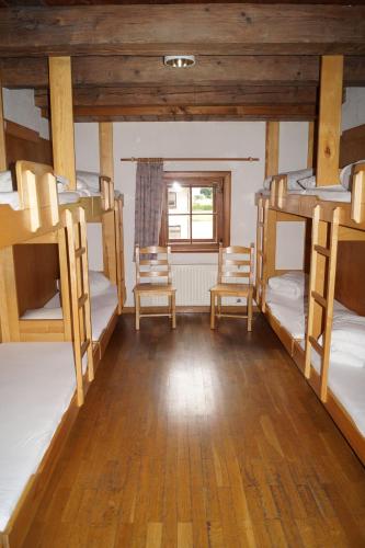 a room with four bunk beds and a window at Jugendherberge Feldkirch in Feldkirch