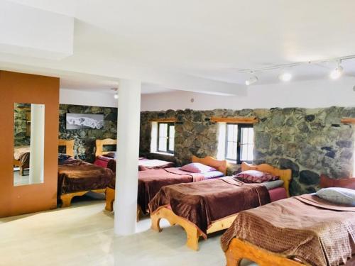 Postel nebo postele na pokoji v ubytování Manoni Ratiani's Guesthouse