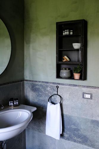 a bathroom with a sink and a white towel at Borgo Castello Panicaglia in Nocera Umbra