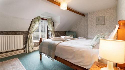 un dormitorio con una cama y una ventana en Maes Glas, en Mallwyd