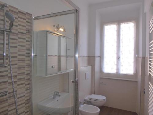 a bathroom with a sink and a toilet and a window at La Casa Del Merlo by Holiday World in Sestri Levante