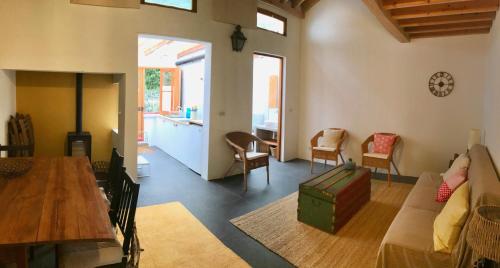 a living room with a couch and a table at #Areias Houses 7 in Furnas