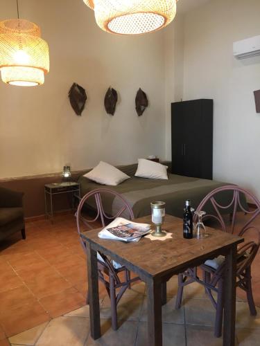 a room with a table and a couch and a bed at Darcilla Guest House in Tarifa