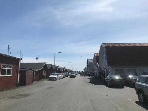 a street with cars parked on the side of the road at Klovabo Bed & Breakfast in Hönö