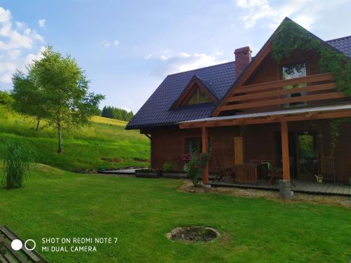 a house with a green lawn in front of it at Dom pod Wilczym Groniem in Rajcza