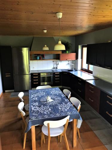 a kitchen with a table and chairs in it at Dom pod Wilczym Groniem in Rajcza