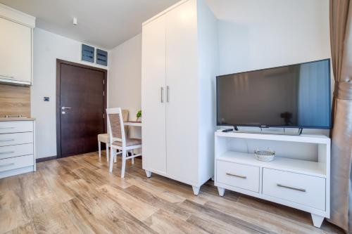 a living room with a tv and a white cabinet at Casa Nuova in Kotor