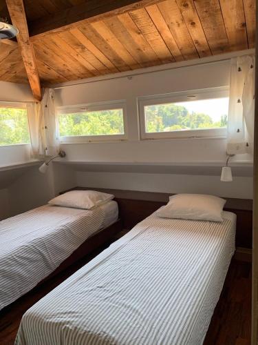 deux lits dans une chambre avec deux fenêtres dans l'établissement Spacious Dream Villa near Monaco, à Roquebrune-Cap-Martin