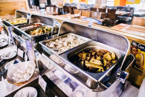 a buffet line with different types of food in trays at Optima Vinnytsia in Vinnytsya