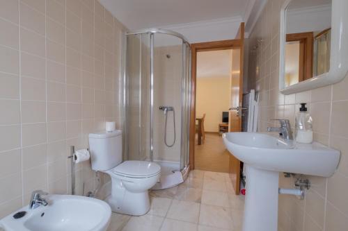 a bathroom with a toilet and a shower and a sink at Apartments Madeira Old Town in Funchal
