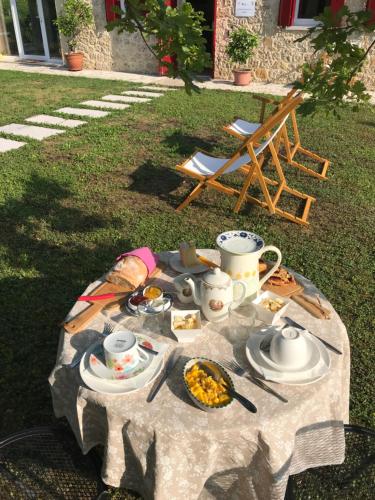 a table with food and cups and plates on it at Agriturismo Lemire in San Pietro di Feletto