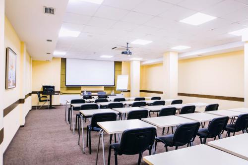 a classroom with tables and chairs and a whiteboard at Optima Vinnytsia in Vinnytsya