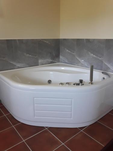 a white bath tub sitting in a bathroom at L'Orto sul Poggio in Sutri
