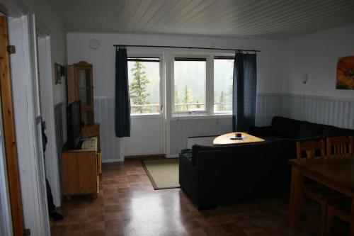 a living room with a couch and a window at Brostigen 5, Vemdalsskalet in Vemdalen