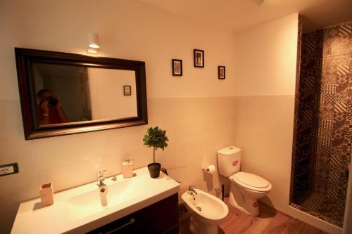 a person taking a picture of a bathroom at Katana suites beach in Agnone Bagni