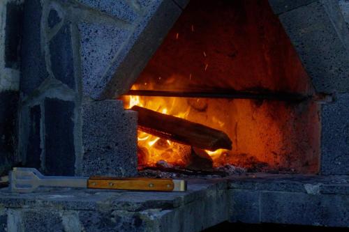 a brick oven with a fire in it at Country House in Azores - S. Miguel in Ribeira Grande