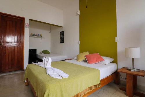 a hotel room with two beds with towels on them at Wabi Hostel in Playa del Carmen
