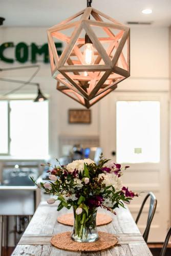 a vase of flowers on a table with a light fixture at Studio 555 in Granville