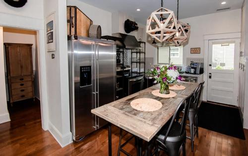 a kitchen with a table and a stainless steel refrigerator at Studio 555 in Granville