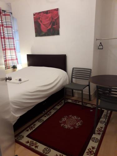 a bedroom with a bed and a table and a table at 20 East Tenter Street in London