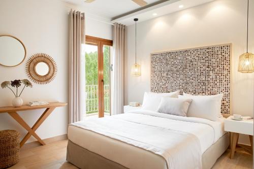 a bedroom with a large bed and a window at S & O Villas Corfu in Dassia