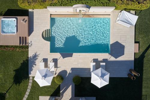 an overhead view of a swimming pool with umbrellas at S & O Villas Corfu in Dassia
