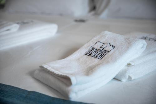 a pair of white socks sitting on a bed at Epic Falésia Apartment by The Portuguese Butler in Olhos de Água