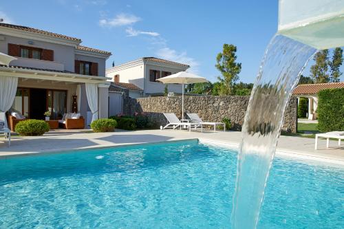 a water fountain in the middle of a swimming pool at S & O Villas Corfu in Dassia