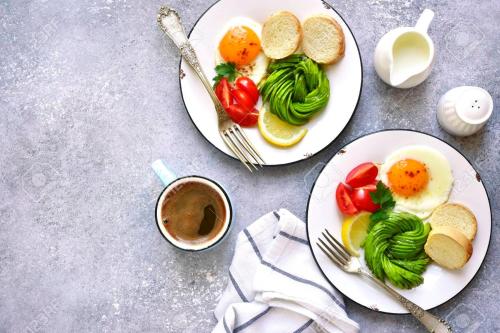 two plates of food with eggs and vegetables and a cup of coffee at St Francis Resort in Georgetown