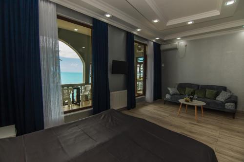 a living room with a couch and a table at House at the Sea in Batumi